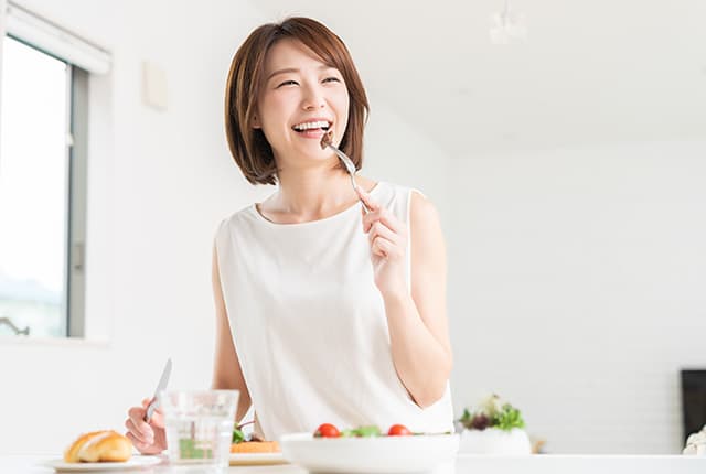 笑顔で食事する女性